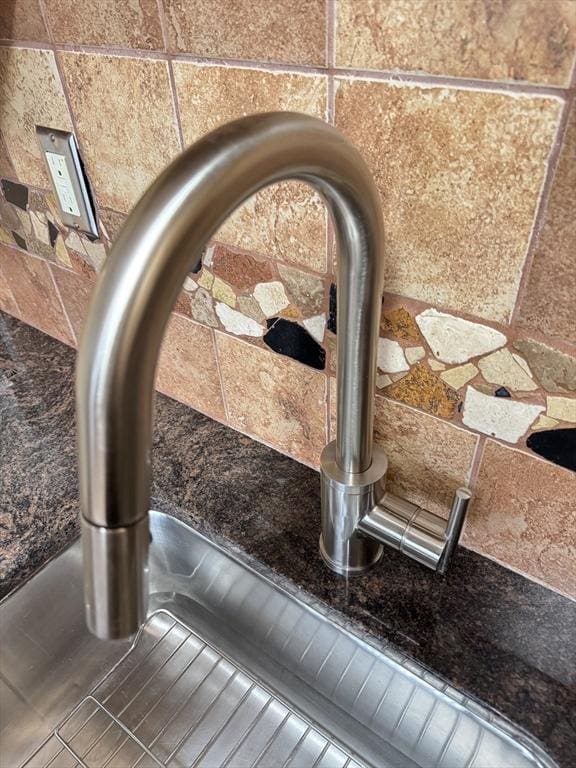 interior details featuring stone countertops and sink