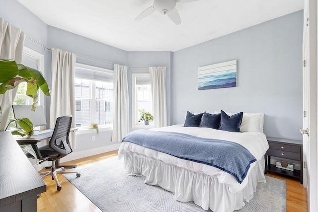 474 E 3rd Unit 2, Boston, MA 02127 - bedroom with light wood finished floors, a desk, a ceiling fan, and baseboards