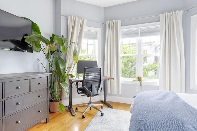 474 E 3rd Unit 2, Boston, MA 02127 - bedroom with light wood finished floors, multiple windows, baseboards, and an office area