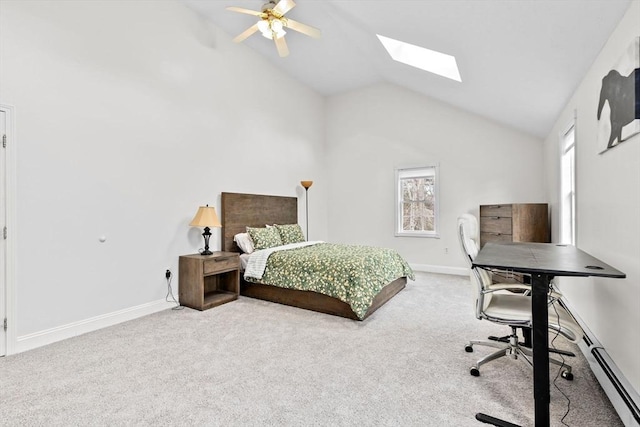 carpeted bedroom featuring lofted ceiling with skylight, ceiling fan, and a baseboard heating unit