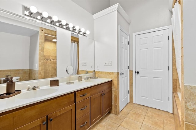 bathroom with tile patterned flooring, vanity, tile walls, and walk in shower