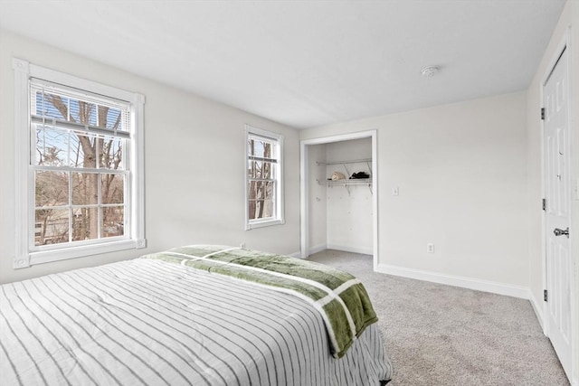 bedroom with light colored carpet and a closet