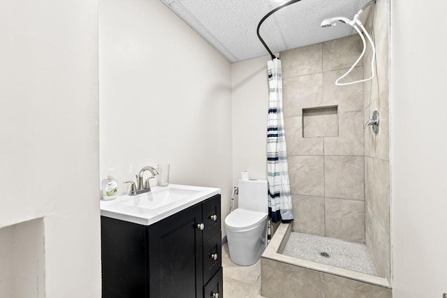 bathroom featuring a textured ceiling, vanity, tile patterned flooring, toilet, and curtained shower