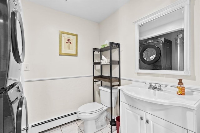 bathroom with tile patterned flooring, a baseboard heating unit, stacked washer / dryer, toilet, and vanity