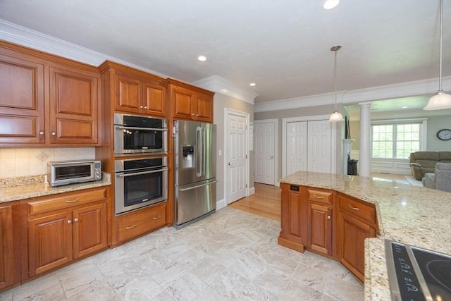 2 Powers Rd, Mendon, MA 01756 - kitchen featuring appliances with stainless steel finishes, crown molding, decorative columns, brown cabinetry, and hanging light fixtures