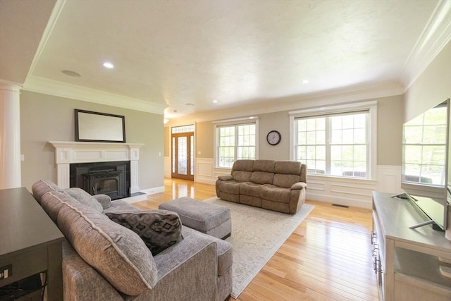 2 Powers Rd, Mendon, MA 01756 - living area with crown molding, light wood finished floors, wainscoting, a fireplace with raised hearth, and ornate columns
