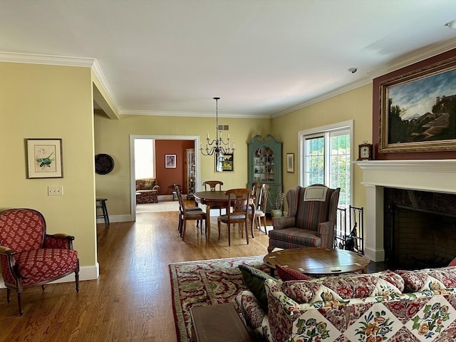 living room featuring wood finished floors, a high end fireplace, crown molding, baseboards, and a chandelier