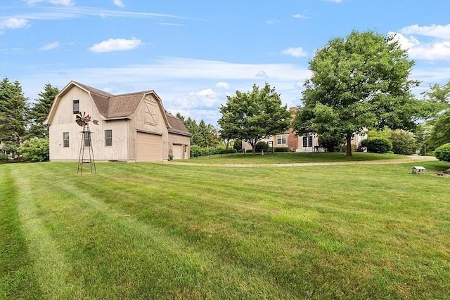 view of yard featuring a garage, an outbuilding, and a barn