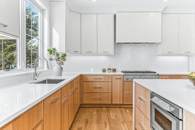 kitchen featuring stainless steel appliances, white cabinetry, sink, and a healthy amount of sunlight