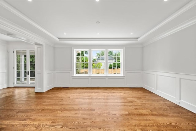 61 Heath St, Brookline, MA 02445 - empty room with healthy amount of natural light, a decorative wall, light wood-type flooring, a raised ceiling, and crown molding