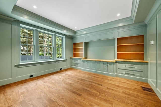 61 Heath St, Brookline, MA 02445 - unfurnished room featuring a decorative wall, ornamental molding, built in features, and light wood-style flooring