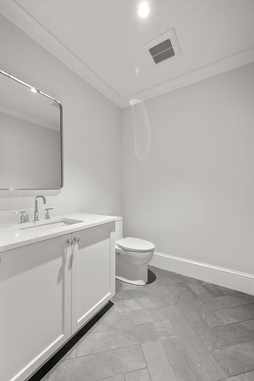 61 Heath St, Brookline, MA 02445 - bathroom with vanity, toilet, and baseboards