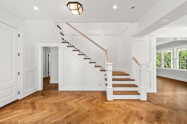 61 Heath St, Brookline, MA 02445 - staircase featuring a decorative wall, crown molding, recessed lighting, and baseboards