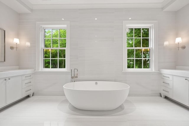 61 Heath St, Brookline, MA 02445 - bathroom featuring vanity, tile walls, a freestanding tub, and tile patterned floors