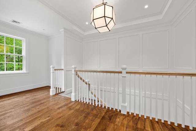 61 Heath St, Brookline, MA 02445 - hallway with an upstairs landing, a decorative wall, wood finished floors, ornamental molding, and recessed lighting