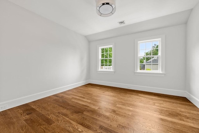 61 Heath St, Brookline, MA 02445 - empty room featuring baseboards, wood finished floors, and lofted ceiling