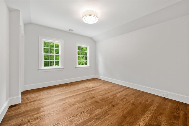 61 Heath St, Brookline, MA 02445 - spare room with vaulted ceiling, baseboards, and wood finished floors