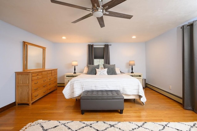 bedroom with ceiling fan, a baseboard radiator, and light hardwood / wood-style floors