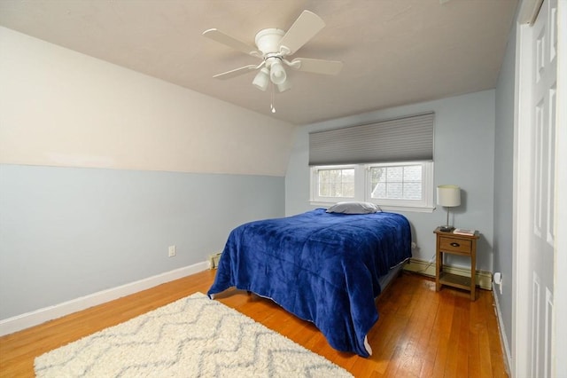 bedroom featuring hardwood / wood-style flooring, ceiling fan, and vaulted ceiling