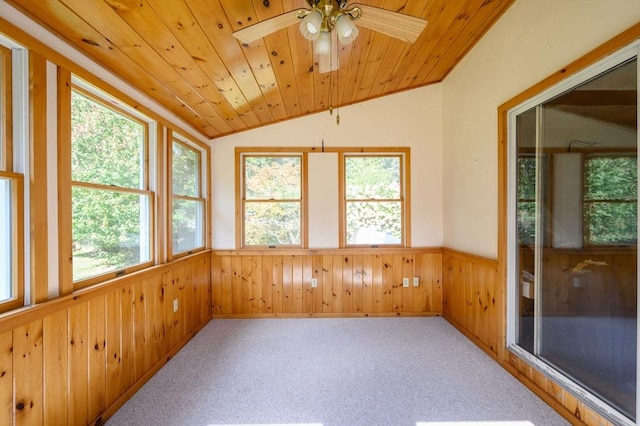 unfurnished sunroom featuring ceiling fan, plenty of natural light, wood ceiling, and vaulted ceiling