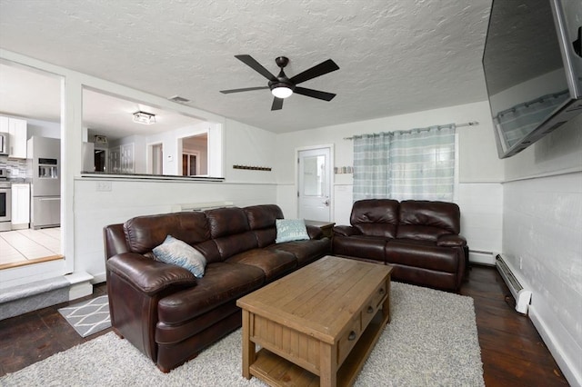 living room featuring dark hardwood / wood-style floors, ceiling fan, a textured ceiling, and a baseboard radiator