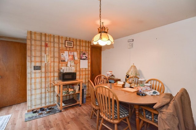 dining space with light hardwood / wood-style flooring