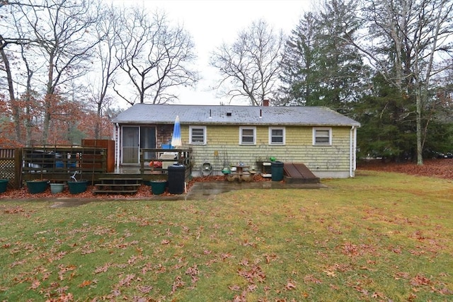 back of house with a yard and a wooden deck