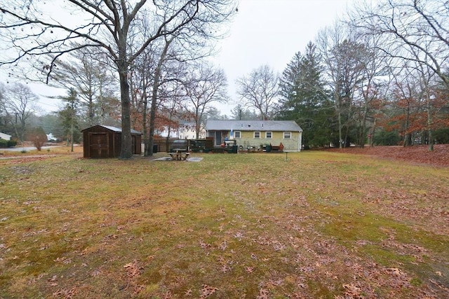 view of yard featuring a deck and a storage unit