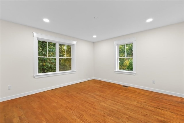 spare room featuring hardwood / wood-style floors