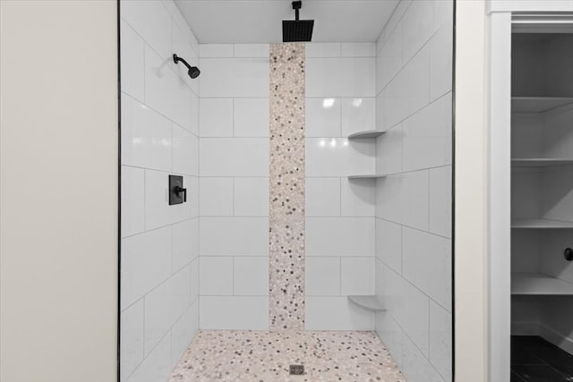 bathroom with a tile shower