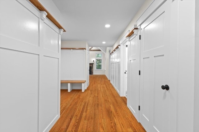 hallway featuring a barn door and light wood-type flooring