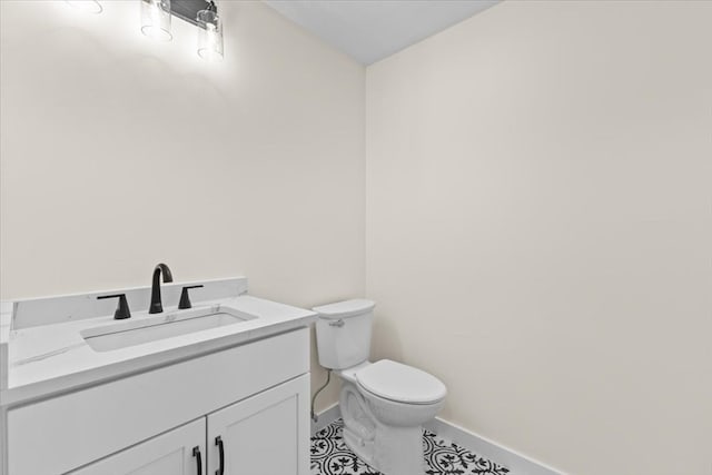 bathroom featuring vanity, tile patterned flooring, and toilet