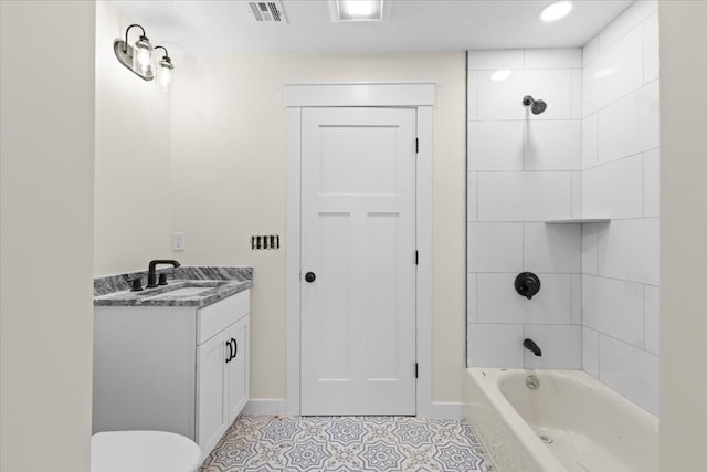 full bathroom with toilet, tile patterned flooring, vanity, and tiled shower / bath combo