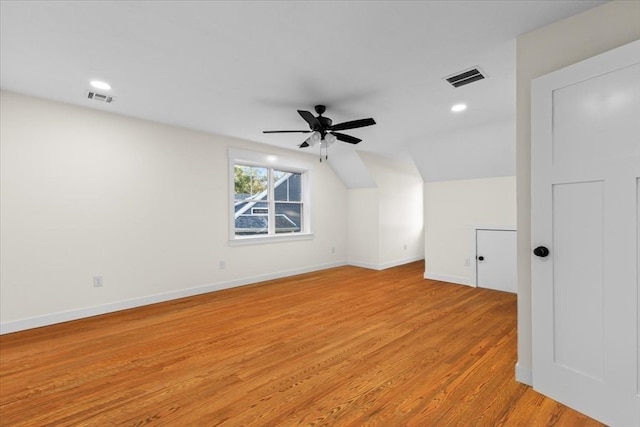 additional living space with light wood-type flooring, ceiling fan, and lofted ceiling