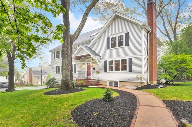 traditional home featuring a chimney and a front yard