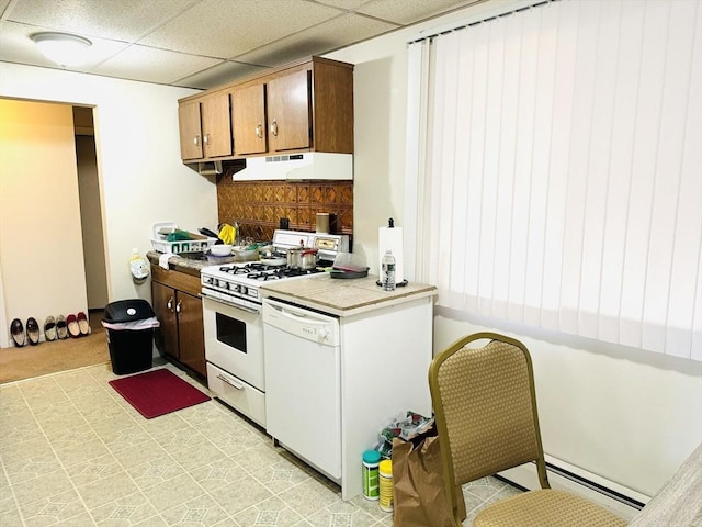 kitchen with a paneled ceiling and white appliances