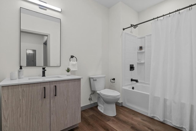 bathroom with vanity, shower / bathtub combination with curtain, wood finished floors, baseboards, and toilet