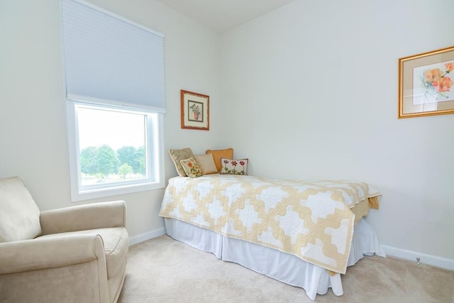 carpeted bedroom featuring baseboards