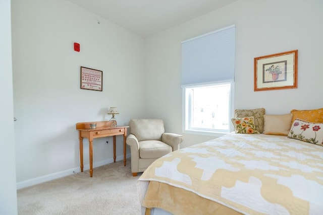 bedroom featuring baseboards and light colored carpet