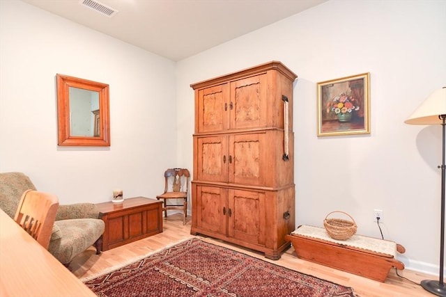 sitting room with visible vents and light wood-style floors