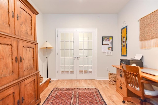 office featuring french doors, baseboards, and light wood-style flooring