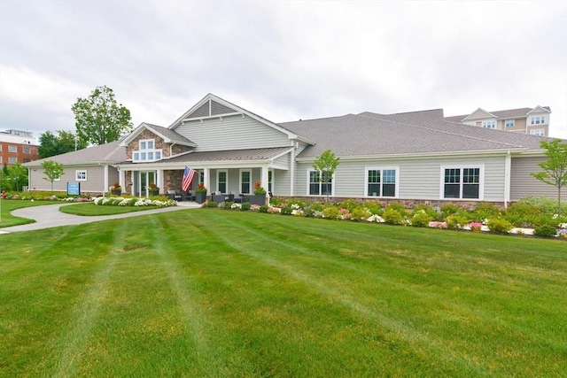 craftsman house featuring stone siding and a front yard