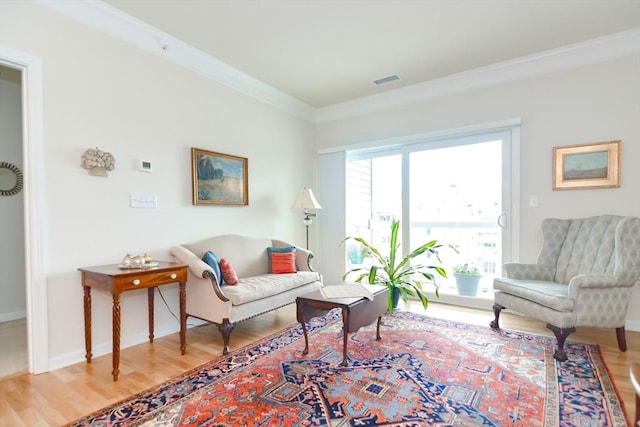 living room featuring crown molding, wood finished floors, visible vents, and baseboards