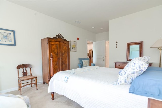 bedroom with light colored carpet, visible vents, and baseboards