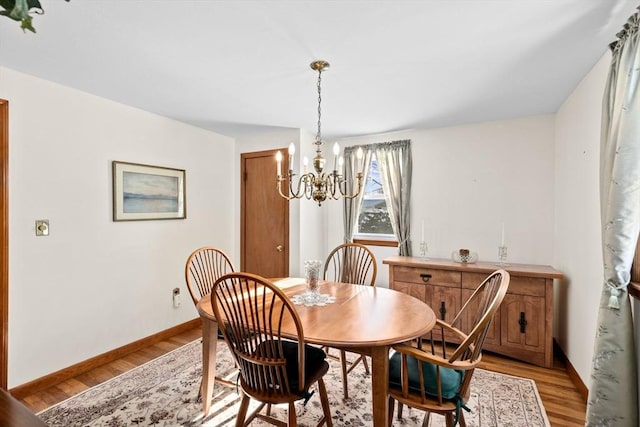 dining area with a chandelier and light wood-type flooring