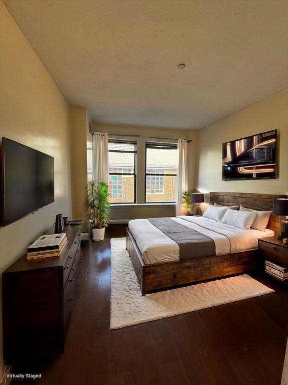 bedroom with dark wood-type flooring