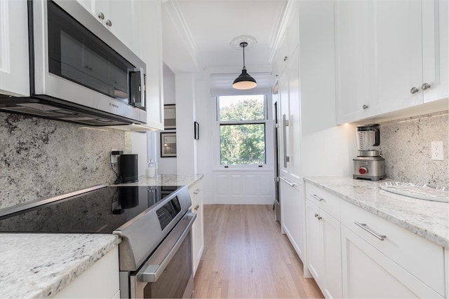 kitchen with backsplash, light stone countertops, stainless steel appliances, and hanging light fixtures