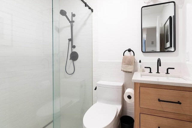 bathroom with vanity, an enclosed shower, tile walls, and toilet