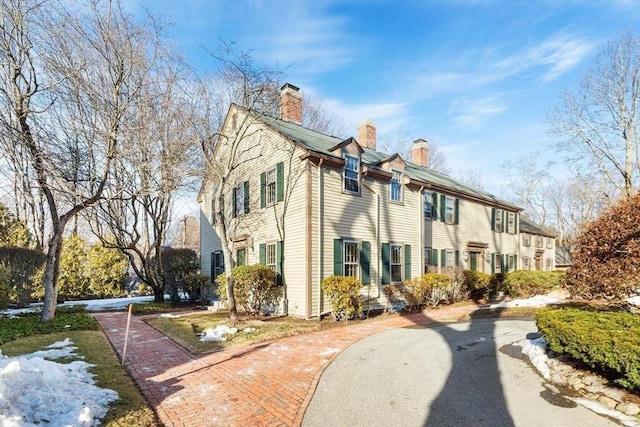 view of property exterior featuring a chimney