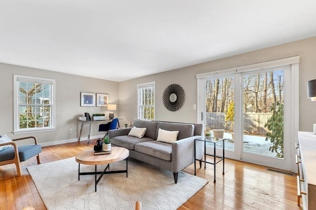 living room featuring light wood finished floors and baseboards